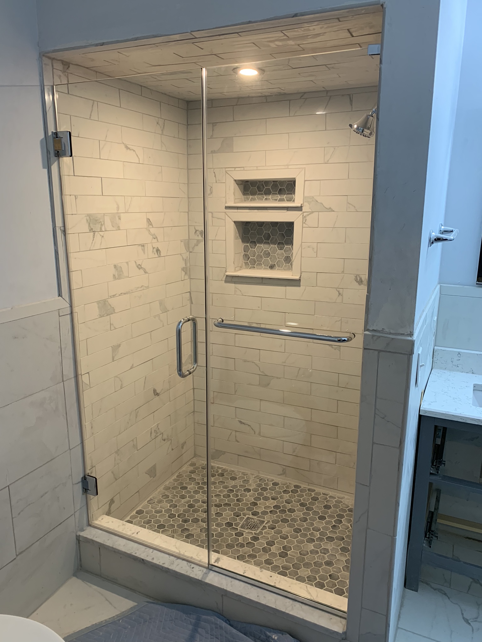 Glass to Glass Inline shower door and panels installed by Harmony Glass