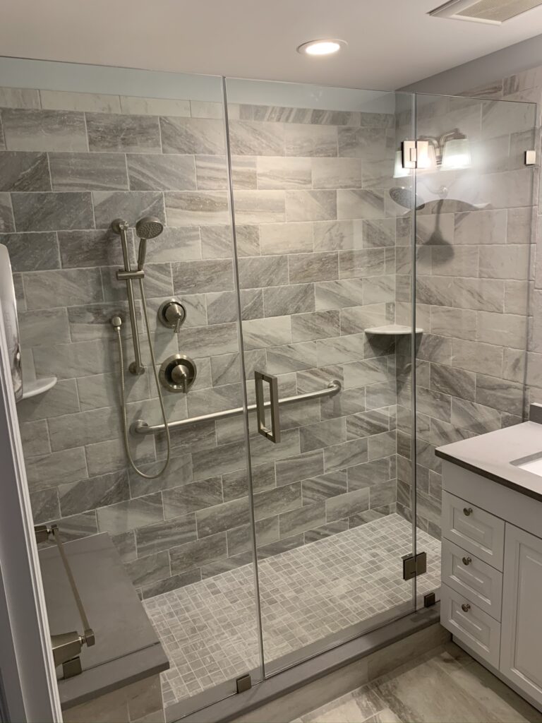 Glass to Glass Inline shower door and panels installed by Harmony Glass