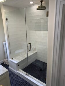 Right hinged door & panel with seat cutout instaled and designed by Harmony Glass & Doors